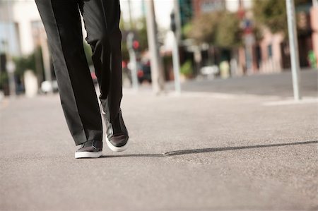 people walking tennis shoes - Legs of a businessman walking on sidewalk Stock Photo - Budget Royalty-Free & Subscription, Code: 400-05379664