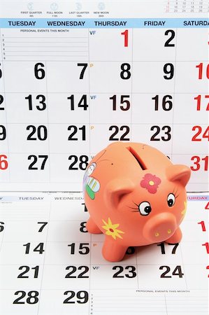 simsearch:400-05201122,k - Close Up of Piggy Bank on Calendar Pages Foto de stock - Royalty-Free Super Valor e Assinatura, Número: 400-05370215