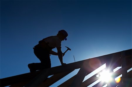 silhouette as carpenter - Builder or carpenter working on the roof - silhouette with strong back light Photographie de stock - Aubaine LD & Abonnement, Code: 400-05370274