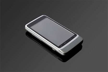 simsearch:400-04836744,k - An Android mobile phone on a black glass table Stock Photo - Budget Royalty-Free & Subscription, Code: 400-05370383