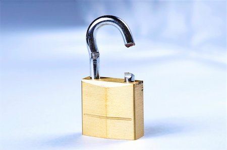 problematic - Image of a broken gold lock with a blue background Stock Photo - Budget Royalty-Free & Subscription, Code: 400-05370412