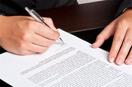 Businesswoman signing a document. Stock Photo - Budget Royalty-Free & Subscription, Code: 400-05370461