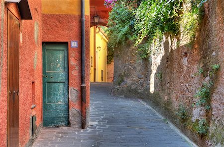 Narrow street among colorful houses and stone wall in Portofino, Italy. Stock Photo - Budget Royalty-Free & Subscription, Code: 400-05370575