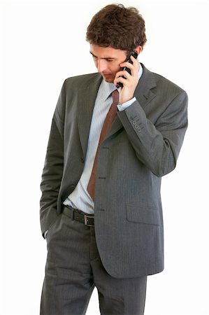 Concerned businessman talking on phone isolated on white Stock Photo - Budget Royalty-Free & Subscription, Code: 400-05370609