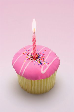 first birthday - Pink candle in cup cake for first birthday Foto de stock - Super Valor sin royalties y Suscripción, Código: 400-05370705