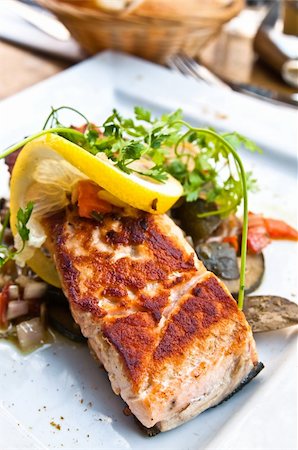 poached salmon - grilled salmon and lemon - french cuisine dish with tomato and salmon Stock Photo - Budget Royalty-Free & Subscription, Code: 400-05371311