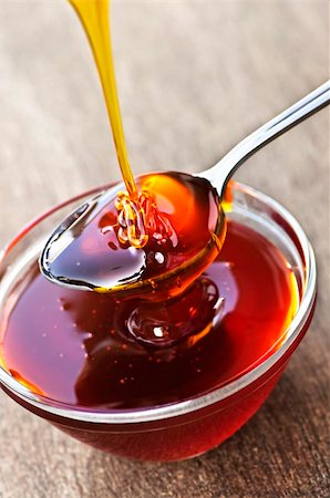 Thick golden honey drizzling onto spoon and bowl Stock Photo - Budget Royalty-Free & Subscription, Code: 400-05372355