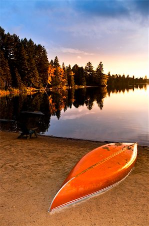 Canoe on beach at sunset on lake shore Stock Photo - Budget Royalty-Free & Subscription, Code: 400-05372375