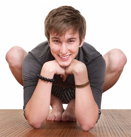 Smiling young man exercises over white background Stock Photo - Budget Royalty-Free & Subscription, Code: 400-05372654