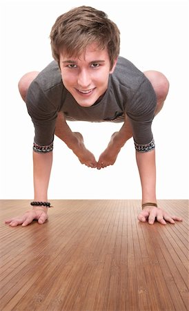 Young Caucasian man in bakasana yoga posture over white background Photographie de stock - Aubaine LD & Abonnement, Code: 400-05372653