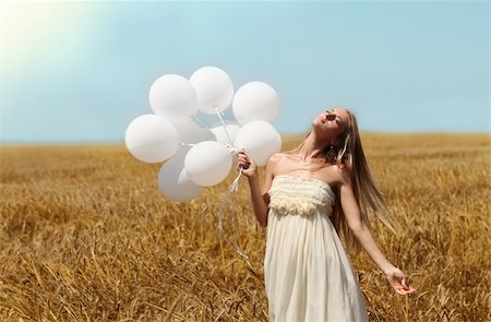 Blond smiling girl with white balloons in the field Stock Photo - Budget Royalty-Free & Subscription, Code: 400-05372682