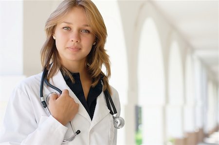 doctors working on teenager - Close-up portrait of a smiling young female doctor Stock Photo - Budget Royalty-Free & Subscription, Code: 400-05373114