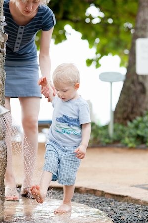 stream body of water - mother helping son to shower feet after beach Stock Photo - Budget Royalty-Free & Subscription, Code: 400-05384046