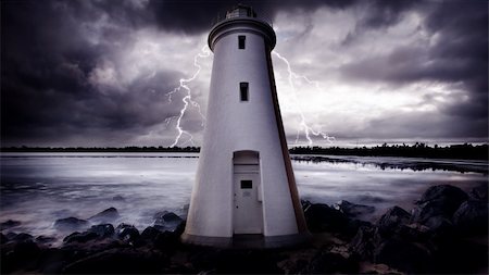 Lightning Strikes behind a lighthouse Photographie de stock - Aubaine LD & Abonnement, Code: 400-05384138