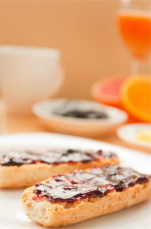 spreading butter on bread - Breakfast with butter and jam and freshly squeezed juice. Stock Photo - Budget Royalty-Free & Subscription, Code: 400-05384749