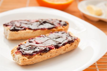 spreading butter on bread - Breakfast with butter and jam and freshly squeezed juice. Stock Photo - Budget Royalty-Free & Subscription, Code: 400-05384750