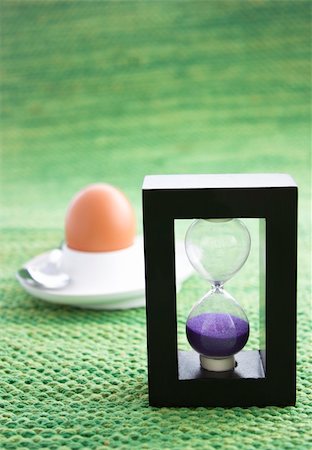 simsearch:700-03660003,k - Sand egg timer with boiled egg in the back. Shallow depth of field. Stock Photo - Budget Royalty-Free & Subscription, Code: 400-05384807