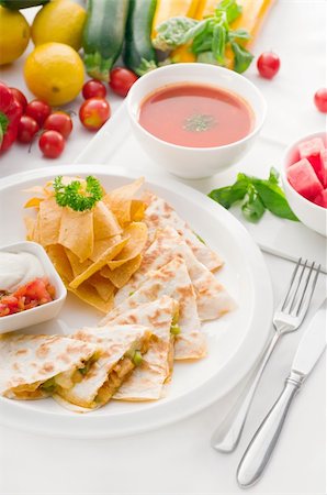 original Mexican quesadilla de pollo with nachos  served with gazpacho soup and watermelon ,with fresh vegetables on background Stock Photo - Budget Royalty-Free & Subscription, Code: 400-05384891