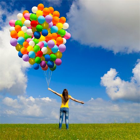 simsearch:400-06077546,k - Happy young woman with colorful balloons on a green meadow Stockbilder - Microstock & Abonnement, Bildnummer: 400-05385584
