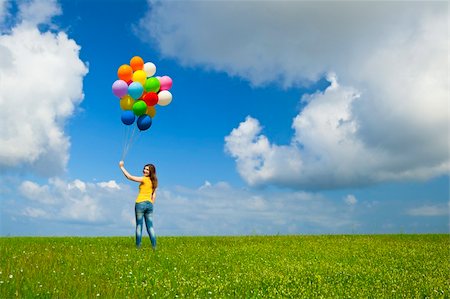 simsearch:400-06077546,k - Happy young woman with colorful balloons on a green meadow Stockbilder - Microstock & Abonnement, Bildnummer: 400-05385587
