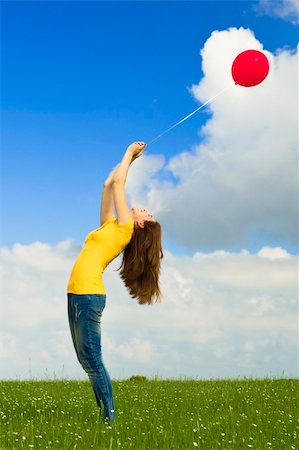 simsearch:400-06077546,k - Happy young woman holding a red balloon on a green meadow Stockbilder - Microstock & Abonnement, Bildnummer: 400-05385589