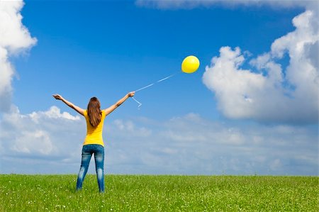 simsearch:400-08262183,k - Happy young woman with a yellow balloon on a green meadow Stock Photo - Budget Royalty-Free & Subscription, Code: 400-05385583