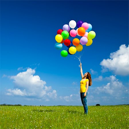 simsearch:400-08262183,k - Happy young woman with colorful balloons on a green meadow Stock Photo - Budget Royalty-Free & Subscription, Code: 400-05385591