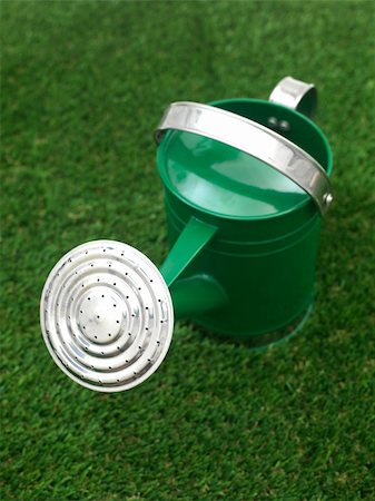 pouring water into a jug - A watering can isolated against a white background Stock Photo - Budget Royalty-Free & Subscription, Code: 400-05385829