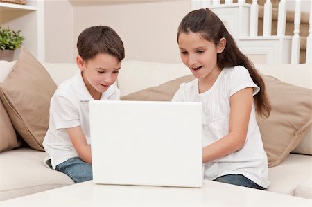 simsearch:400-04575374,k - Young boy & girl children using laptop computer on a sofa at home Stock Photo - Budget Royalty-Free & Subscription, Code: 400-05385968