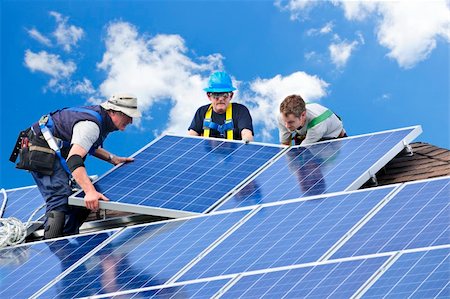 roofer - Workers installing alternative energy photovoltaic solar panels on roof Stock Photo - Budget Royalty-Free & Subscription, Code: 400-05386117