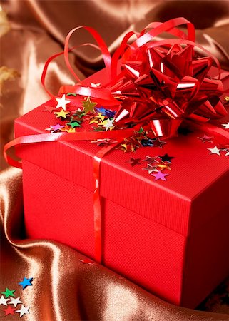 simsearch:400-06172940,k - Red gift box with bows and stars on golden silk background Photographie de stock - Aubaine LD & Abonnement, Code: 400-05386664