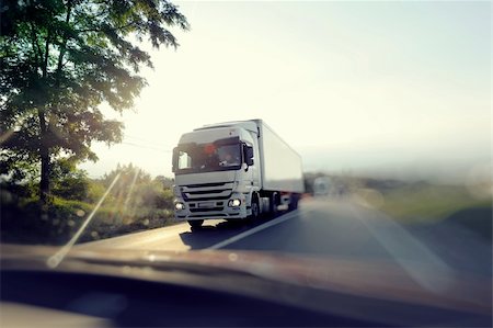 semi truck on highway image - European truck speeding on freeway with colorful ambient colors and blurred motion. View from another passenger car. Stock Photo - Budget Royalty-Free & Subscription, Code: 400-05387576