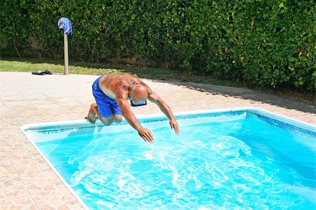 Man jumoing to swimming pool. Stock Photo - Budget Royalty-Free & Subscription, Code: 400-05380214