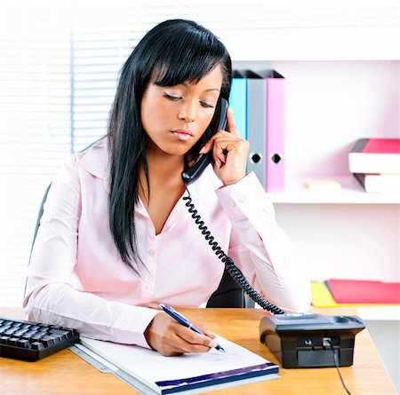simsearch:695-03381231,k - Serious young black business woman on phone taking notes in office Photographie de stock - Aubaine LD & Abonnement, Code: 400-05380314