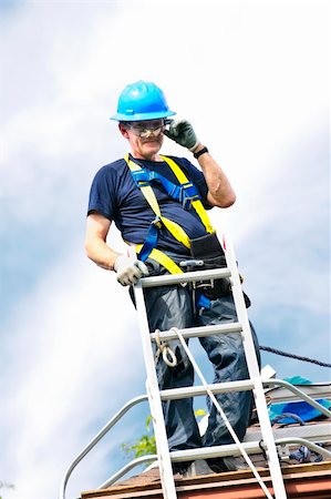 picture of old man construction worker - Construction worker standing on roof near ladder Stock Photo - Budget Royalty-Free & Subscription, Code: 400-05380328