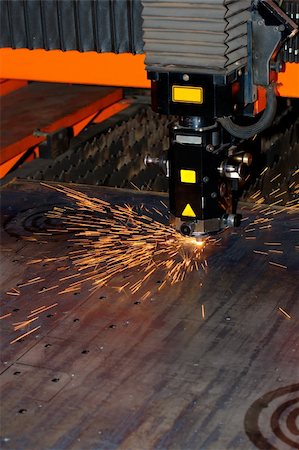 Industrial laser with sparks flying around Stock Photo - Budget Royalty-Free & Subscription, Code: 400-05381140
