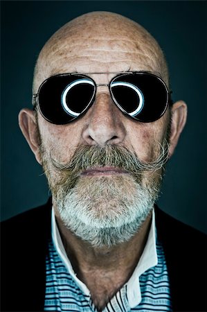 elderly eyes - An old man with a grey beard wearing sunglasses Stock Photo - Budget Royalty-Free & Subscription, Code: 400-05381594