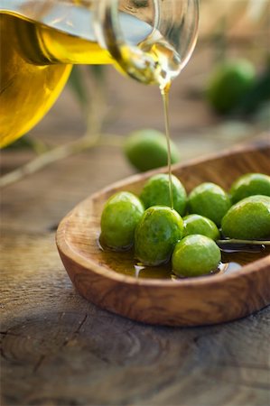 eating olive - Extra virgin healthy Olive oil with fresh olives on rustic wooden background Stock Photo - Budget Royalty-Free & Subscription, Code: 400-05381636