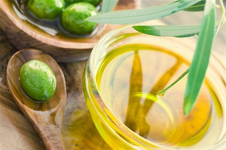 eating olive - Extra virgin healthy Olive oil with fresh olives on rustic wooden background Stock Photo - Budget Royalty-Free & Subscription, Code: 400-05381639