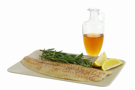 Mediterranean diet dinner ingredients including fresh fish fillet, herbs, lemon and olive oil isolated on white background Stock Photo - Budget Royalty-Free & Subscription, Code: 400-05381790