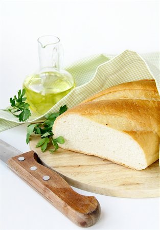 simsearch:400-04421047,k - fresh white loaf of bread with a knife , olive oil , rustic style Foto de stock - Super Valor sin royalties y Suscripción, Código: 400-05381966