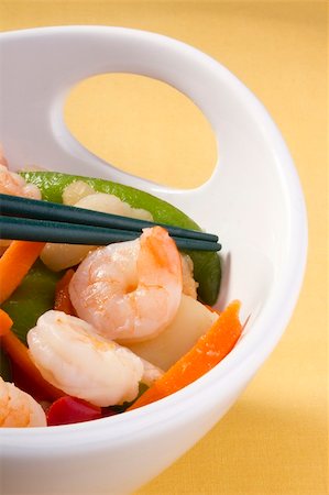 simsearch:400-05745083,k - Asian salad in a white bowl with green chopsticks. Fotografie stock - Microstock e Abbonamento, Codice: 400-05382769