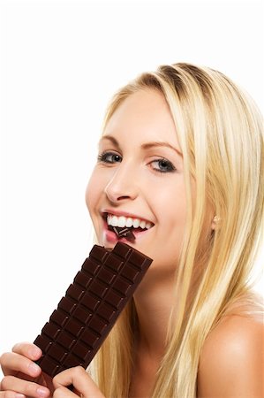 beautiful blonde woman eating a chocolate bar on white background Stock Photo - Budget Royalty-Free & Subscription, Code: 400-05383023