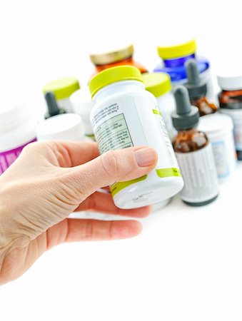 pill bottle in hand - Hand holding medicine bottle to read label Stock Photo - Budget Royalty-Free & Subscription, Code: 400-05383354