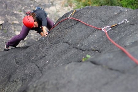 Young woman with helmet climbing basalt rock Foto de stock - Super Valor sin royalties y Suscripción, Código: 400-05383669