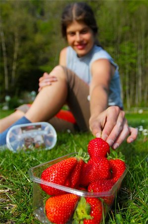 Young woman grabbing for fresh strawberry Stock Photo - Budget Royalty-Free & Subscription, Code: 400-05383672