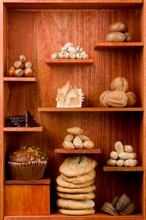 simsearch:400-05692108,k - Assortment of different nuts and foods with nuts in them in a wooden shelf. Foto de stock - Super Valor sin royalties y Suscripción, Código: 400-05383990