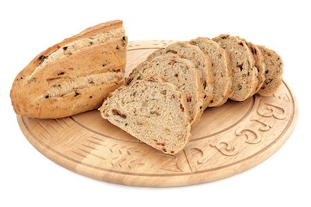 Olive and sun dried tomato bread loaf on a beech wood board isolated over white background. Stock Photo - Budget Royalty-Free & Subscription, Code: 400-05664104