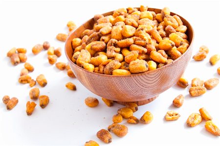 A cherry wood bowl of shelled peanuts on a white background. Foto de stock - Super Valor sin royalties y Suscripción, Código: 400-05665521