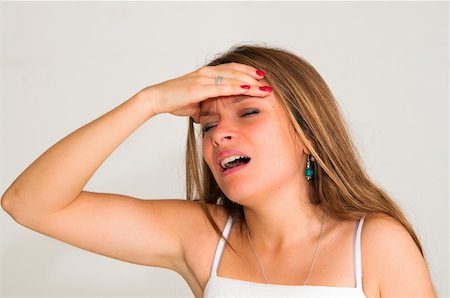 simsearch:400-07485414,k - young woman with headache holding her hand to the head Fotografie stock - Microstock e Abbonamento, Codice: 400-05665673